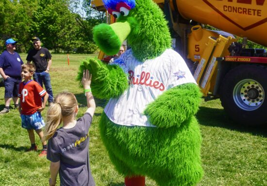 A photo of the Phillie Phanatic interacting with an attendee at the Silvi Foundation Touch-a-Truck.
