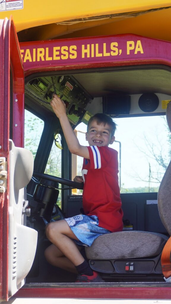 A picture of an attendee exploring the inside of a concrete mixer at the Silvi Foundation Touch-a-Truck.